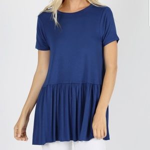 Ruffle top with short sleeves. Plus size available